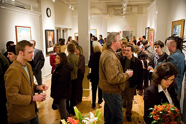 a crowd of people at an art gallery opening