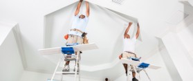 Two men installing crown molding