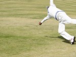 Fielder diving to catch the ball