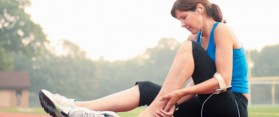 Woman jogger holding injured ankle