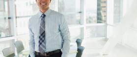 Smiling businessman standing in office