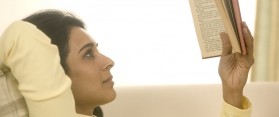 Woman reading book at home