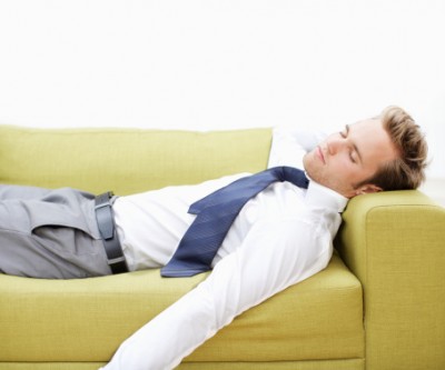 Young businessman relaxing on sofa