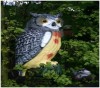 plastic owl in garden