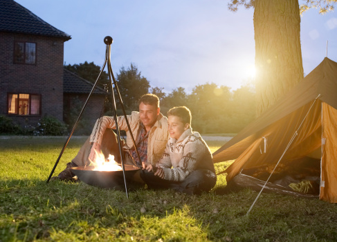 Father and son camping in garden
