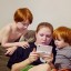Kids playing games with their mother
