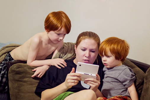 Kids playing games with their mother