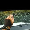 Scrape off glue from windshield