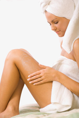 Girl applying body lotion