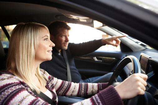 Girl driving with man