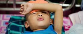 A boy with dengue disease sleep on a bed