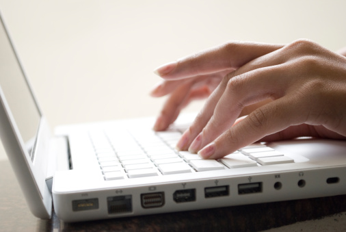 fingers on a laptop keypad