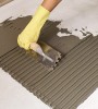 Applying mortar for tile using a notched trowel