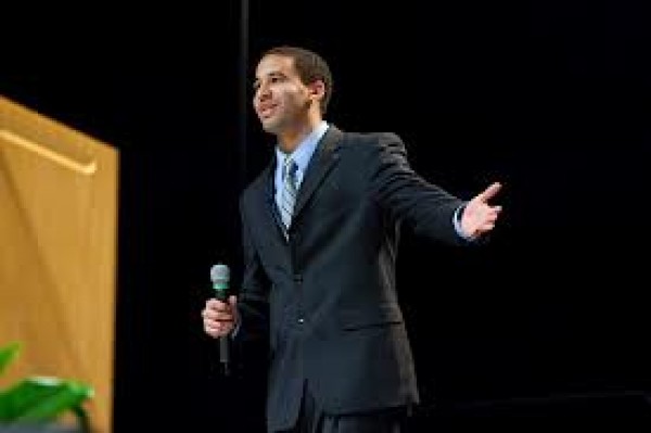 Man Introducing Guest Speakers