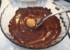 Using fork to cover the balls with chocolate