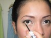 Applying white eye liner