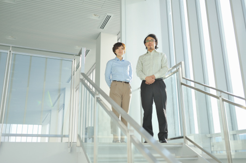 Two people looking down the stairs