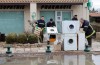 Rescuers collect damaged washing machine