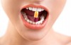 Young Woman's Mouth and Teeth Holding Pill