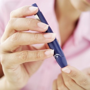 Woman testing blood sugar