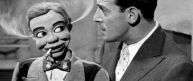 A black and white ventriloquism performance