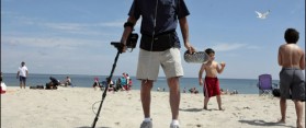 Using a metal detector at the beach