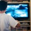 Boy playing at television video games