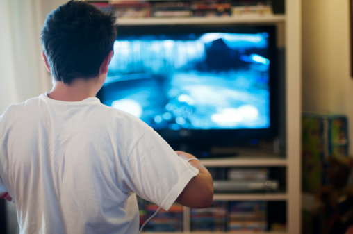 Boy playing at television video games