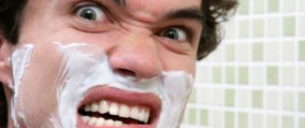 Man Shaving With Razor