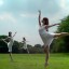 The plural same people do a ballet dance in a park