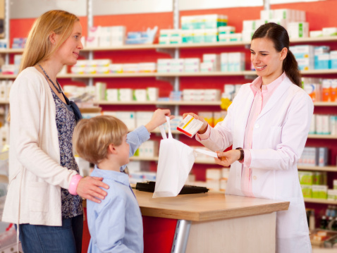 Pharmacist filling prescription in store
