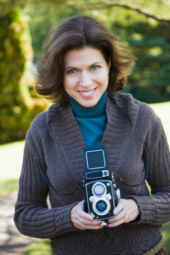 woman holding twin lens camera