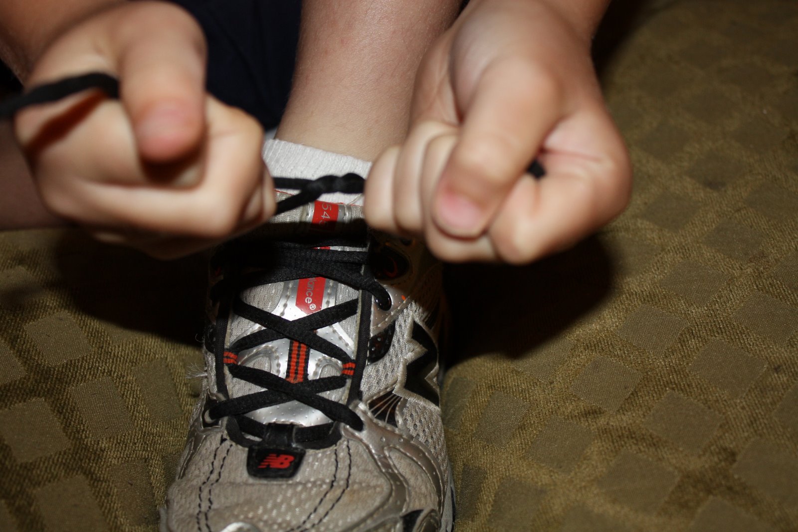 Boy tying shoelaces