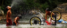Kids washing bicycle