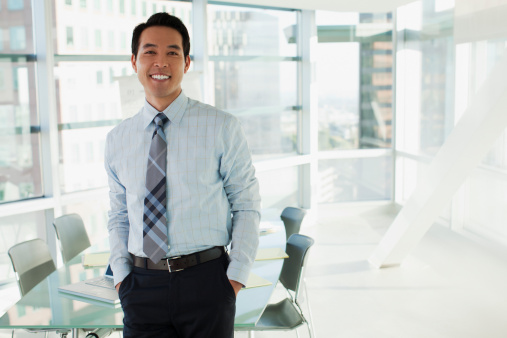 Smiling businessman standing in office