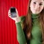 Smiling woman posing with smartphone