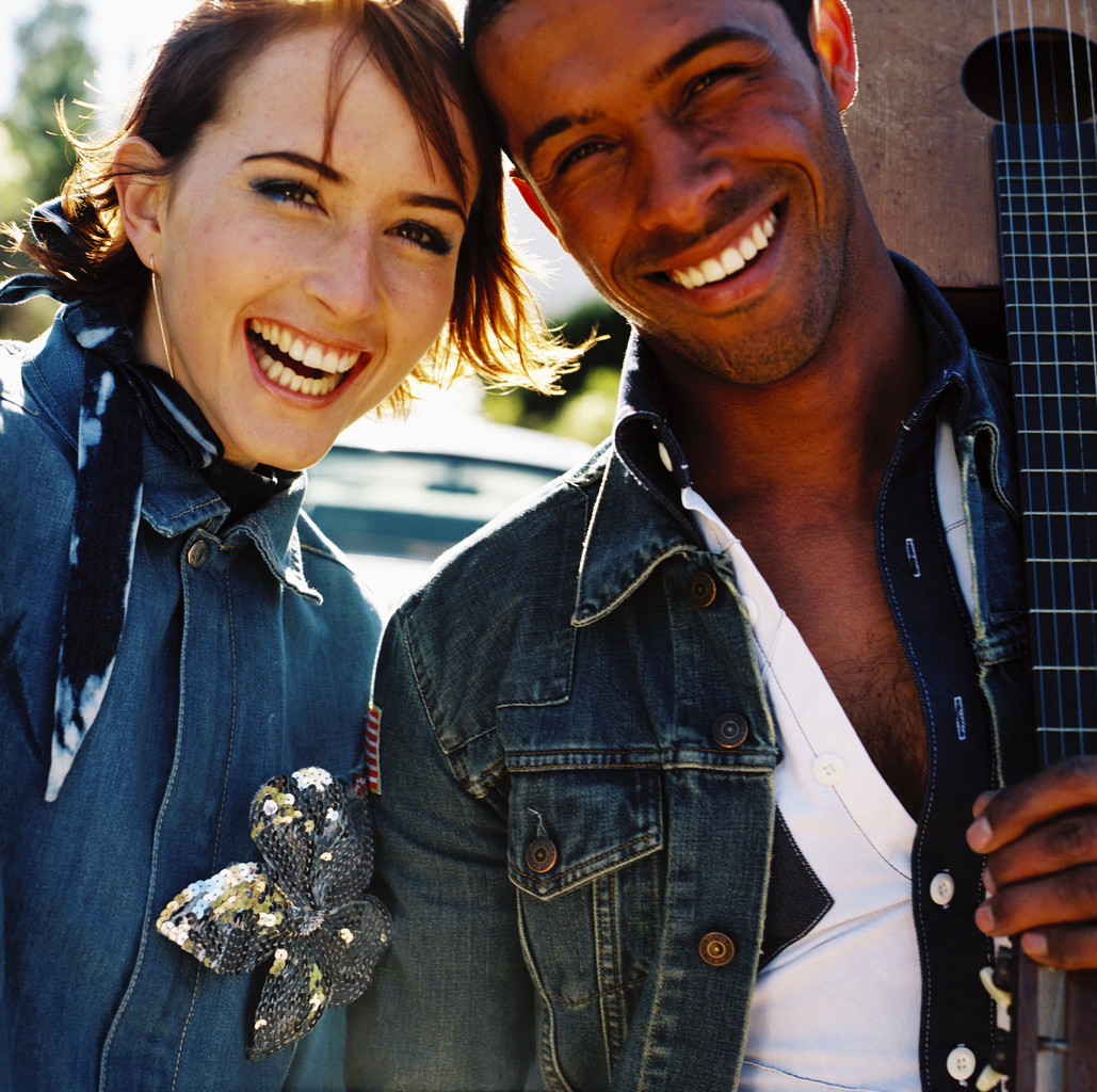 Man and a Woman with Their Heads Together Smiling