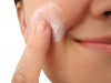 Woman applying moisturizer