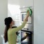 Girl cleaning Microwave