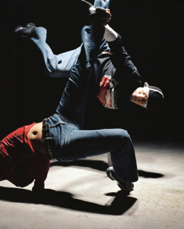 Young man and young woman breakdancing