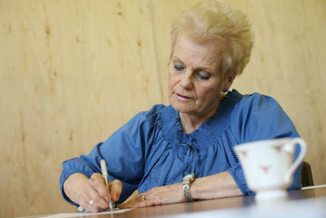 Woman Writing a Heartfelt Sympathy Card