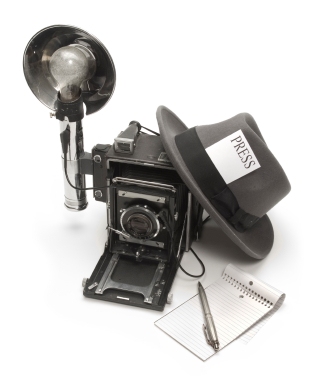 Journalist camera, hat with a press pass, and with notepad