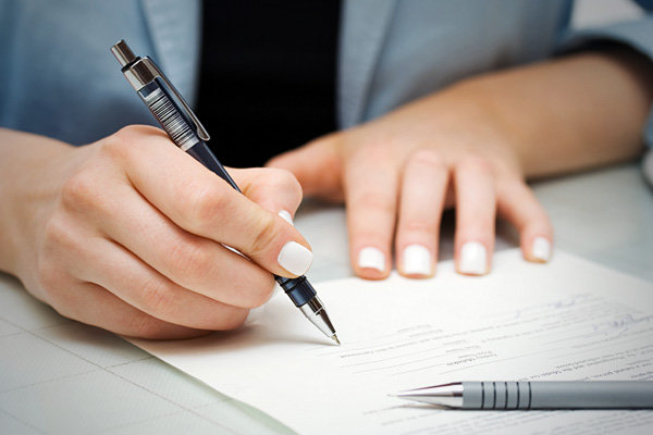 A Person Signing Papers