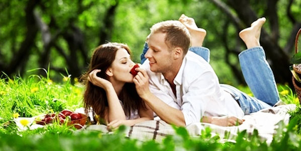 Young enamoured couple on picnic in wood