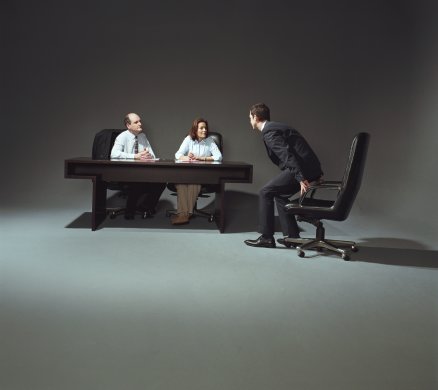 Young businessman being interviewed by two people