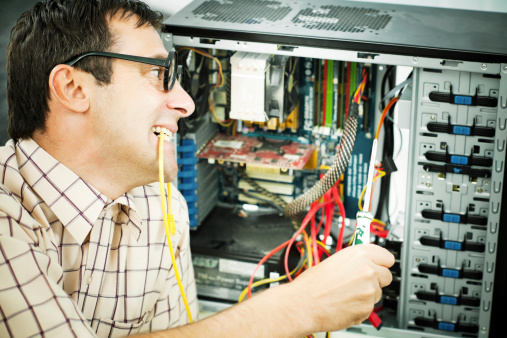 Male geek fixing his computer.