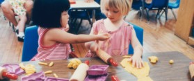 TWO GIRLS PLAYING IN CLASSROOM