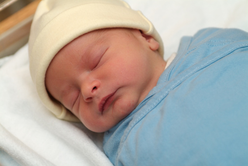 Sleeping Newborn Baby in Miracle Blanket