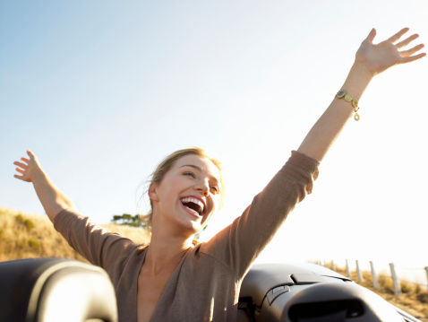 Young Woman Sits in Convertible