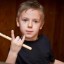 A child with a drum stick